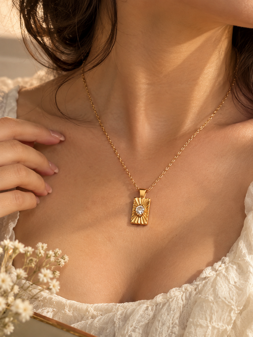 Elegant Gold Sunburst Pendant Necklace - Close up detail shot